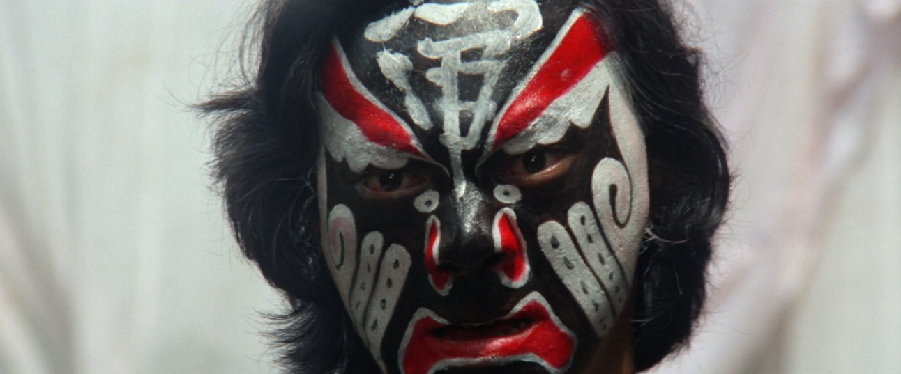 Man with the face painted with traditional pattern