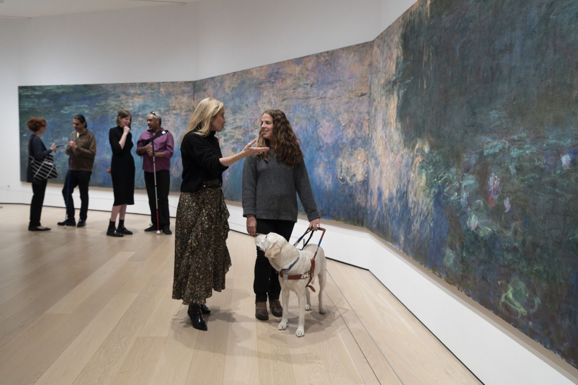 MoMA’s director of Access Programs and Initiatives, Francesca Rosenberg, with visitors on a verbal description tour. Shown: Claude Monet. Water Lilies. 1914–26. Oil on canvas, three panels. The Museum of Modern Art, New York. Mrs. Simon Guggenheim Fund. Photo: Martin Seck