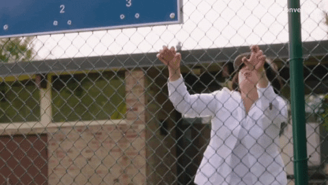 Girl climbing fence