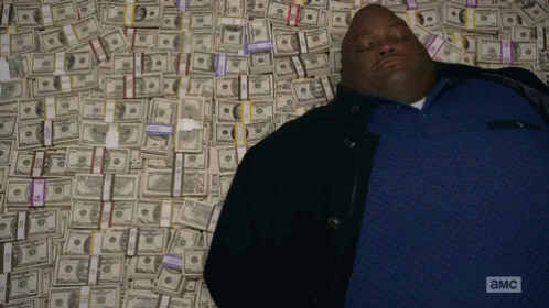 Guy from breaking bad laying on money gif