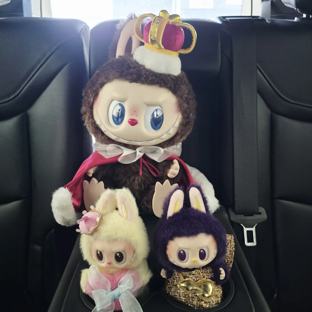 "The soft pastel yellow, pink, and blue tones that blend beautifully in person. The fur is plush and silky to the touch, and the overall look is even cuter and more vibrant than the promo photos. The pastel bow and tiny crown add an extra charming touch, making her stand out among the softer color variants."