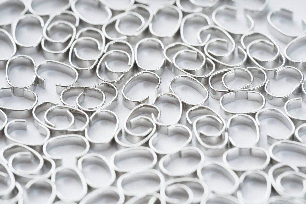 Coated ring travellers — precision manufactured