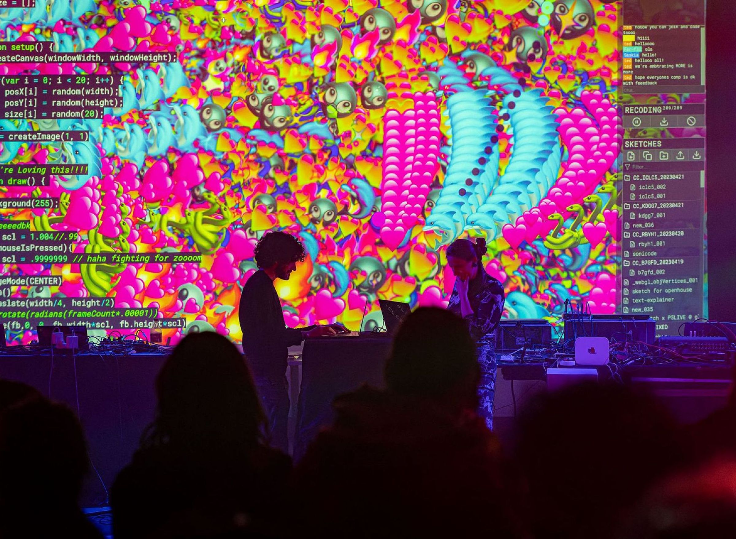 Two people are playing instruments in front of a large projection screen