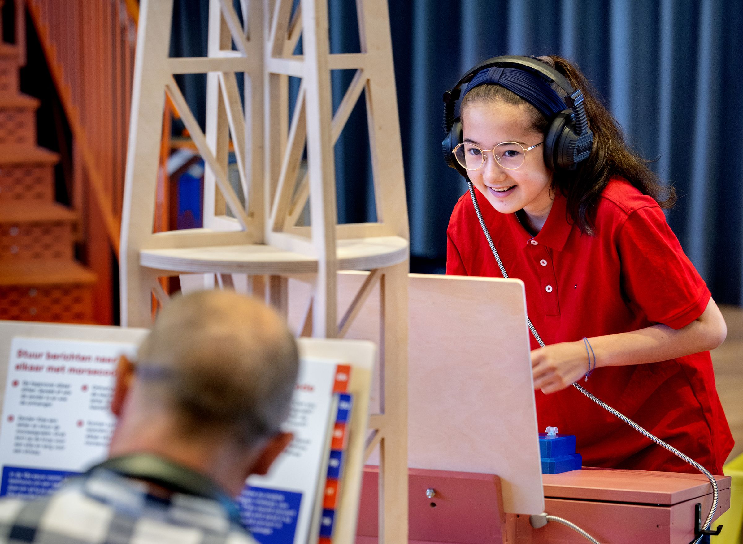 A girl looks at an information board and pushes a button