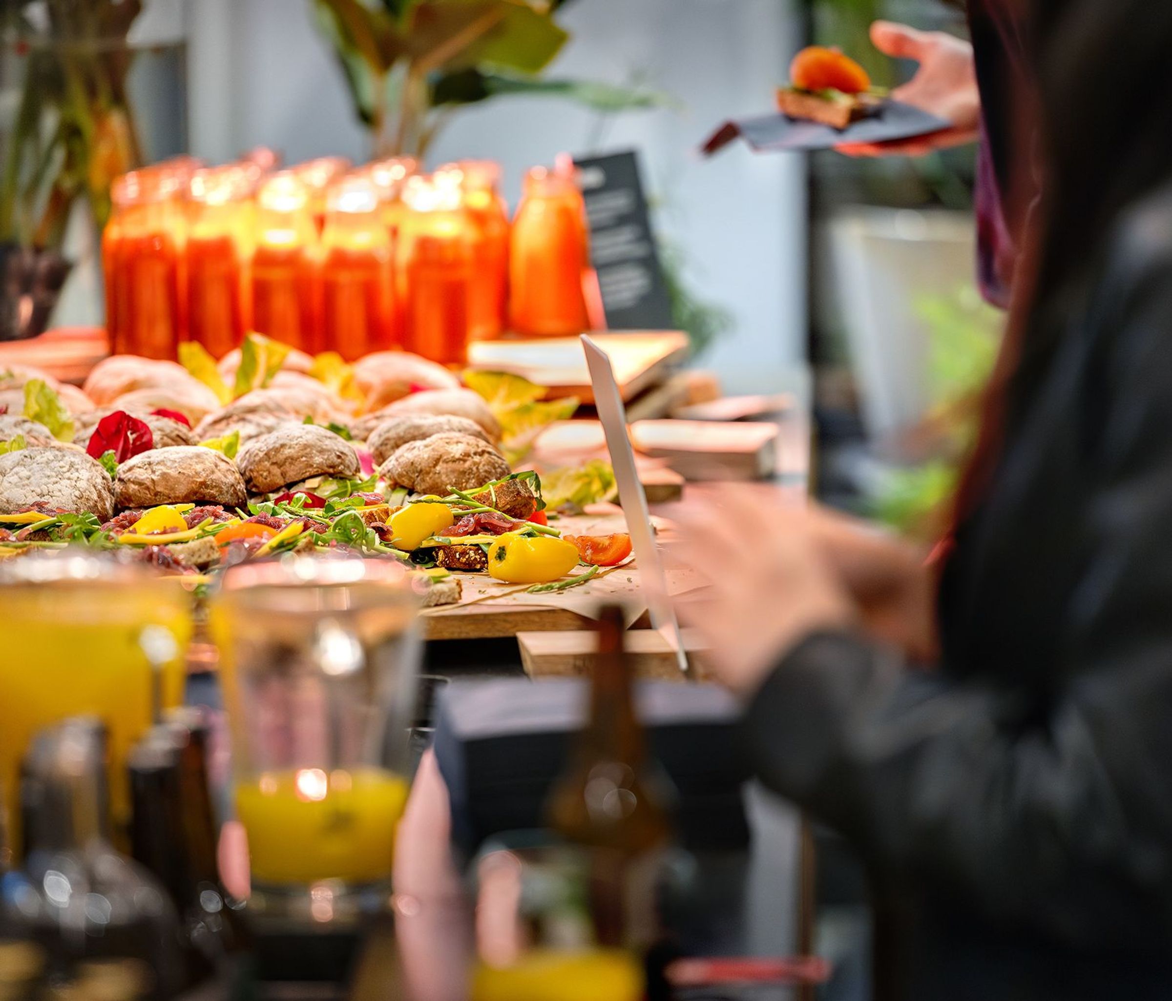 Sandwiches, soups and juices on a buffet.