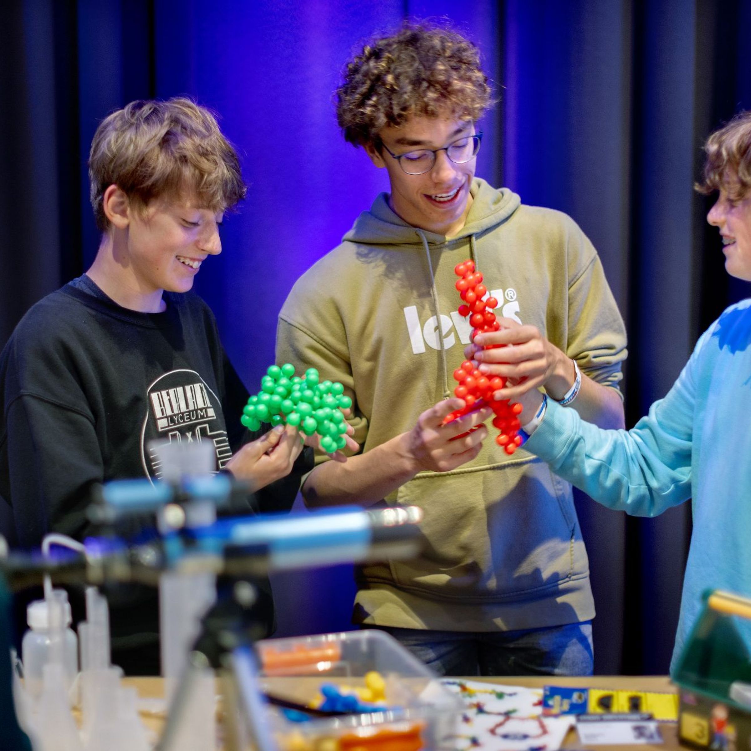 Drie jongens zijn bezig met vormen bestaande uit balletjes.