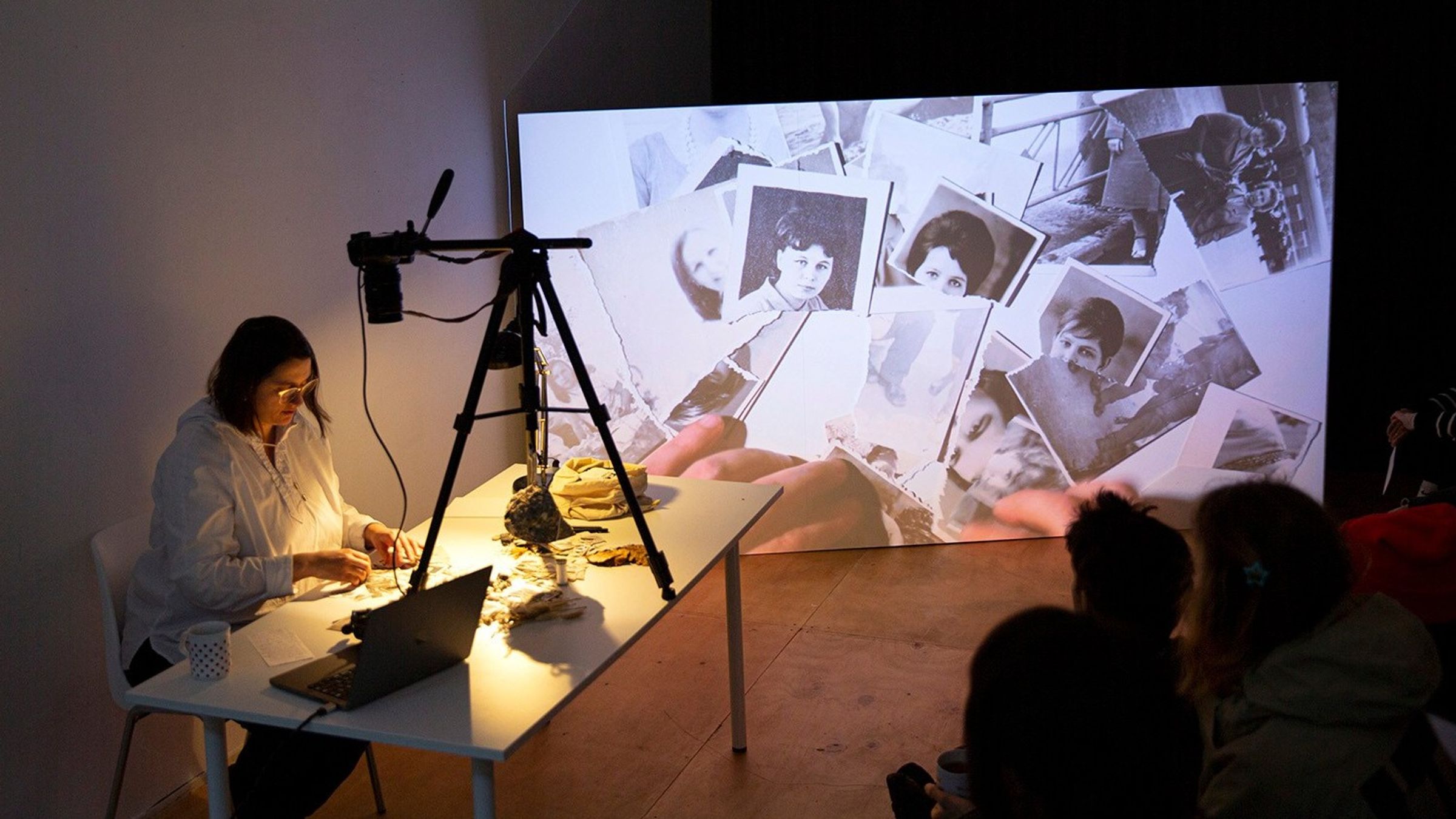 a woman is working with torn photos