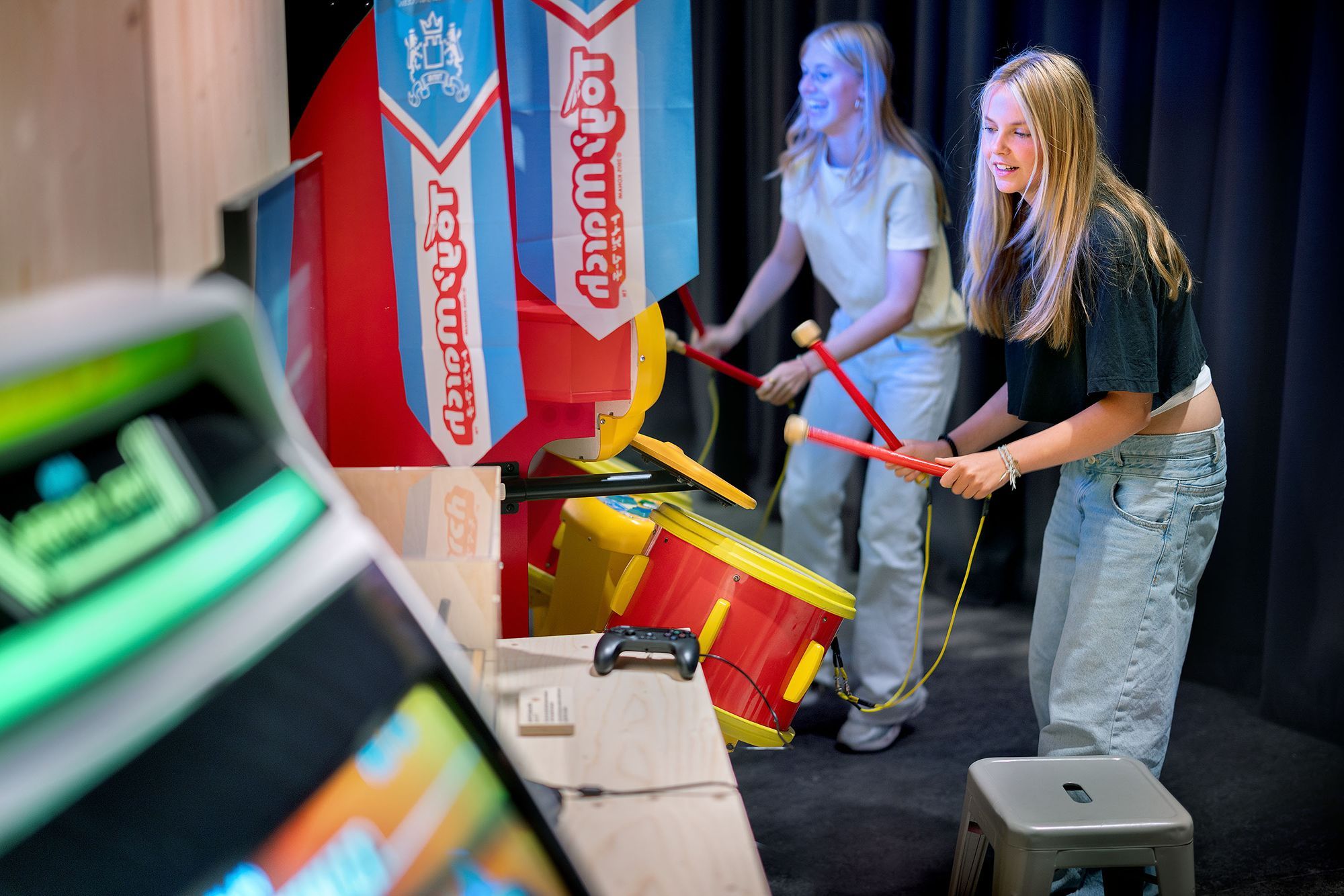 a family of three plays a game in an exhibition space