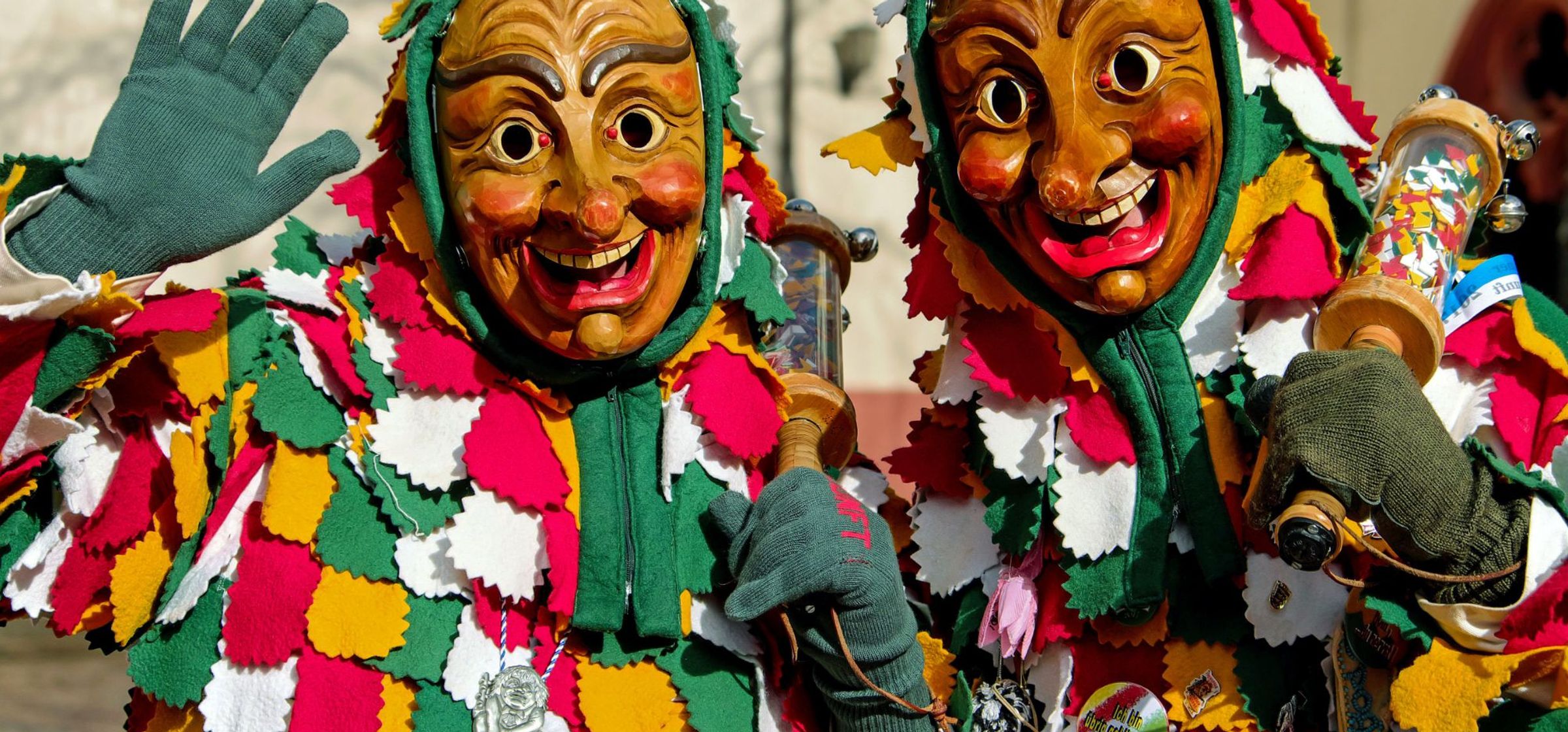 Two people wearing carnival masks.