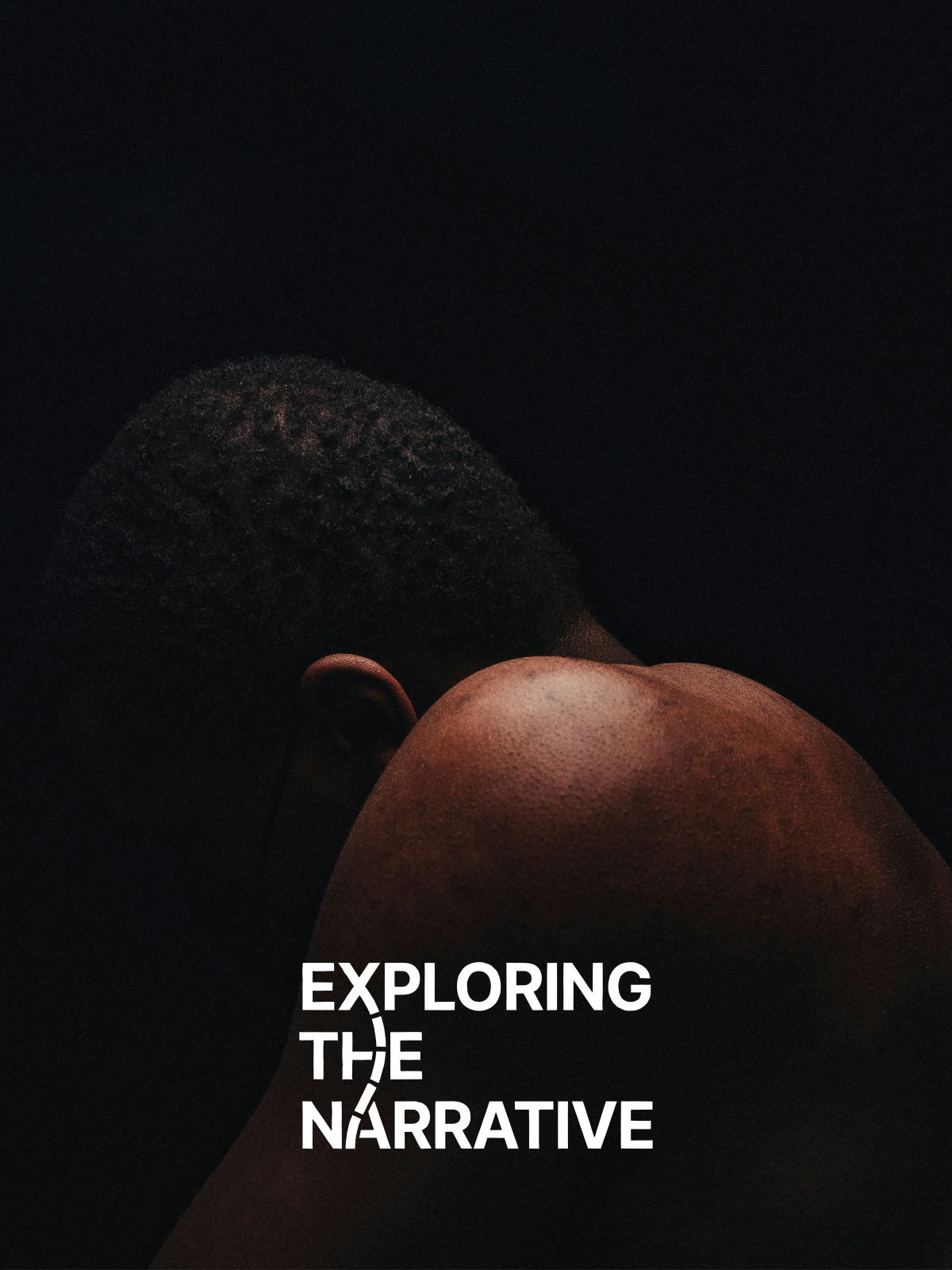 A dark, low-key portrait of a person seen from behind.
