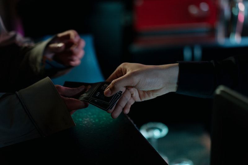 A closeup of two hands exchanging tickets