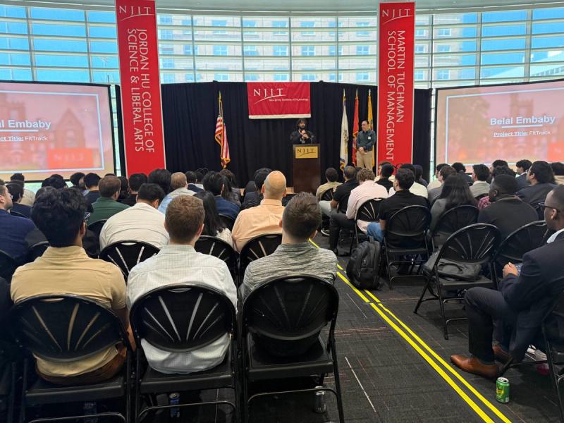 Students presenting capstone project outcomes at a showcase event