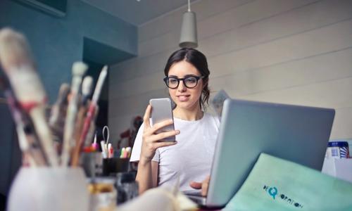 a girl with phone and laptop