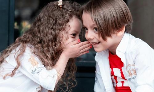 two kids whispering