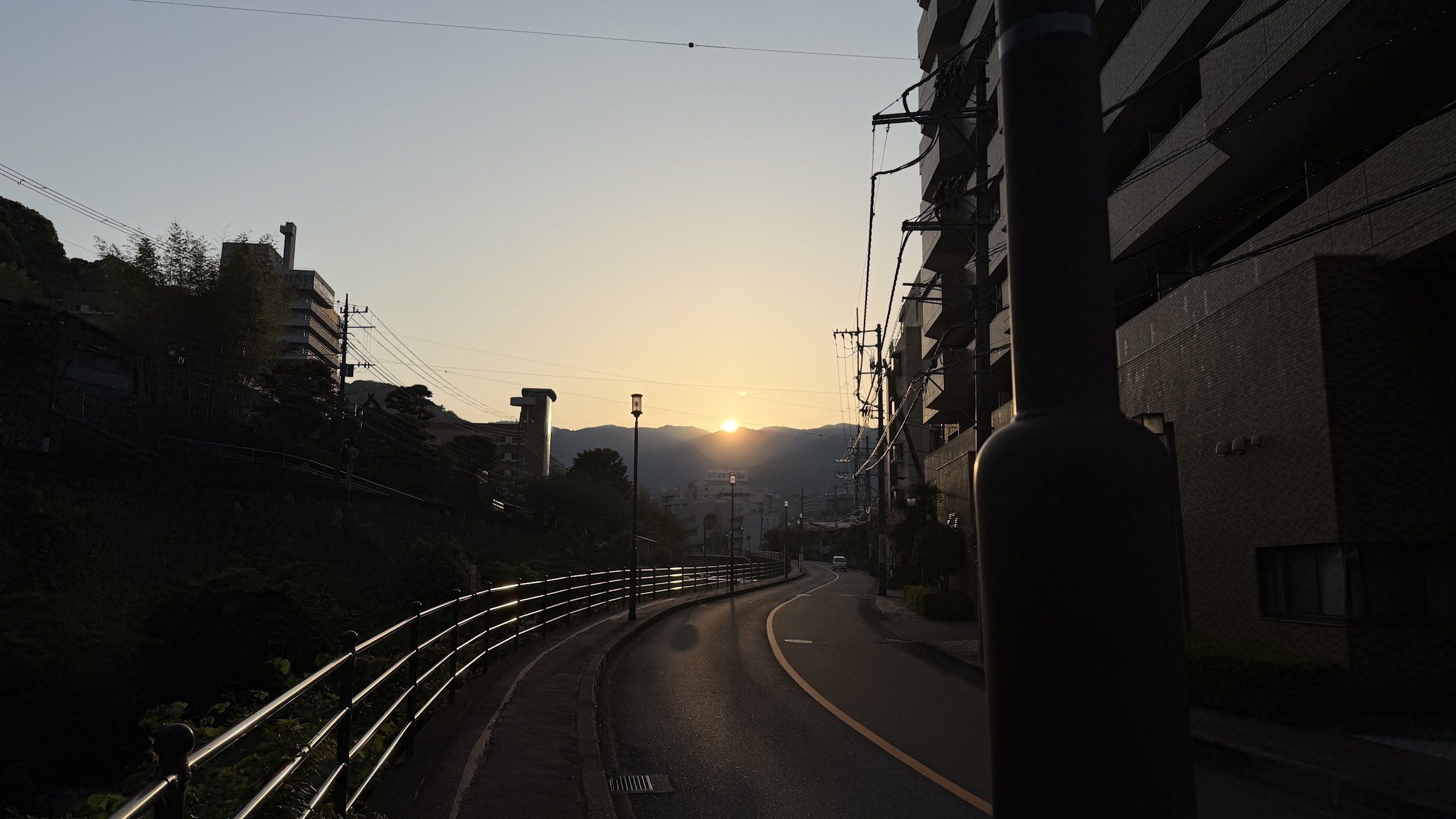 A Yugawara street leading toward the mountains at sunset