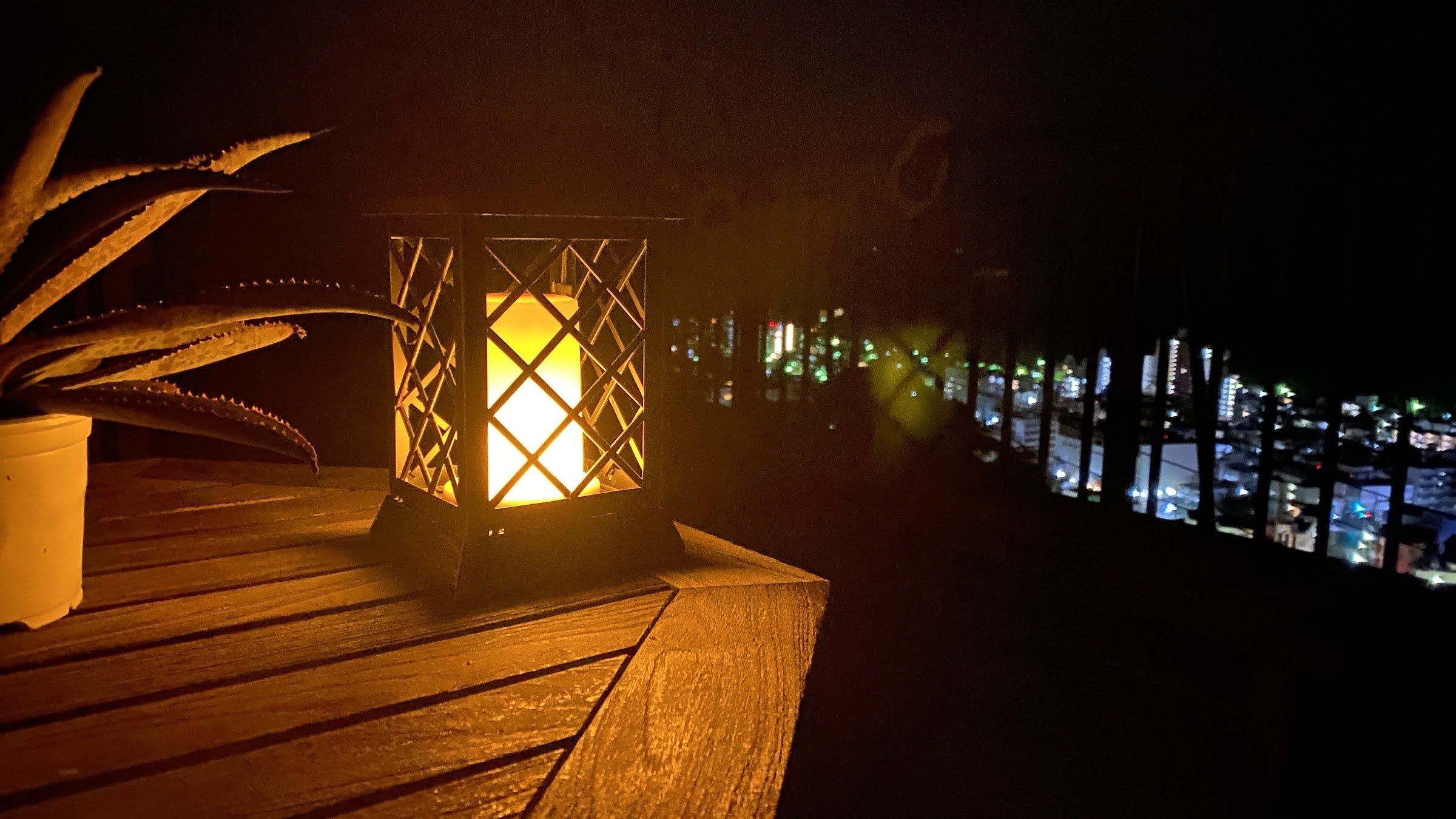 A warm lantern above Yugawara's town lights at night
