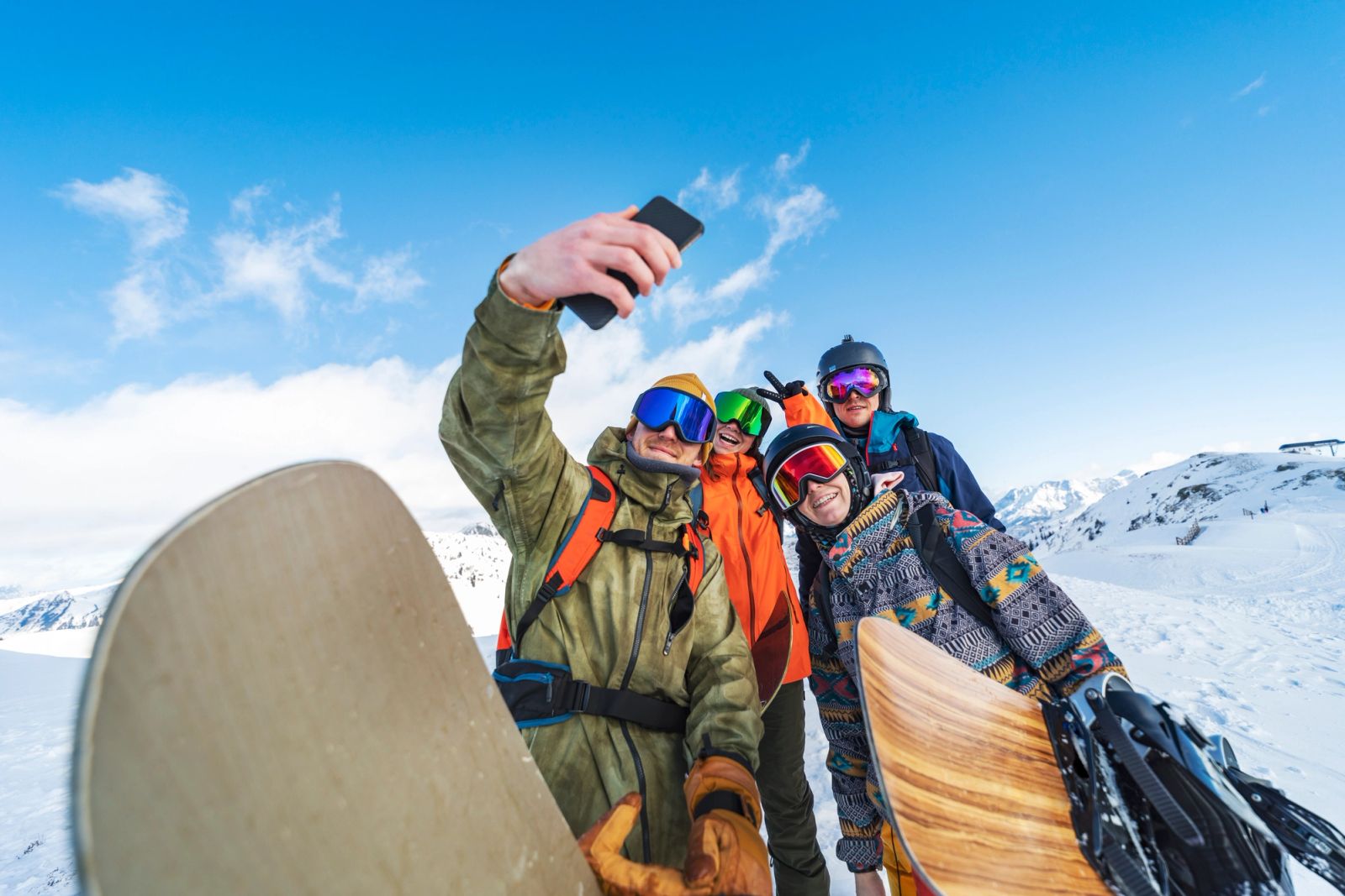 Family of snowboarders getting a selfie