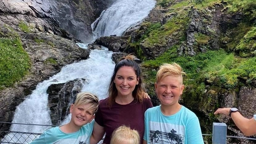 Kjosfossen waterfall Family in front of the Kjosfossen waterfall - Flåm Railway -Sognefjord in a nutshell - Norway