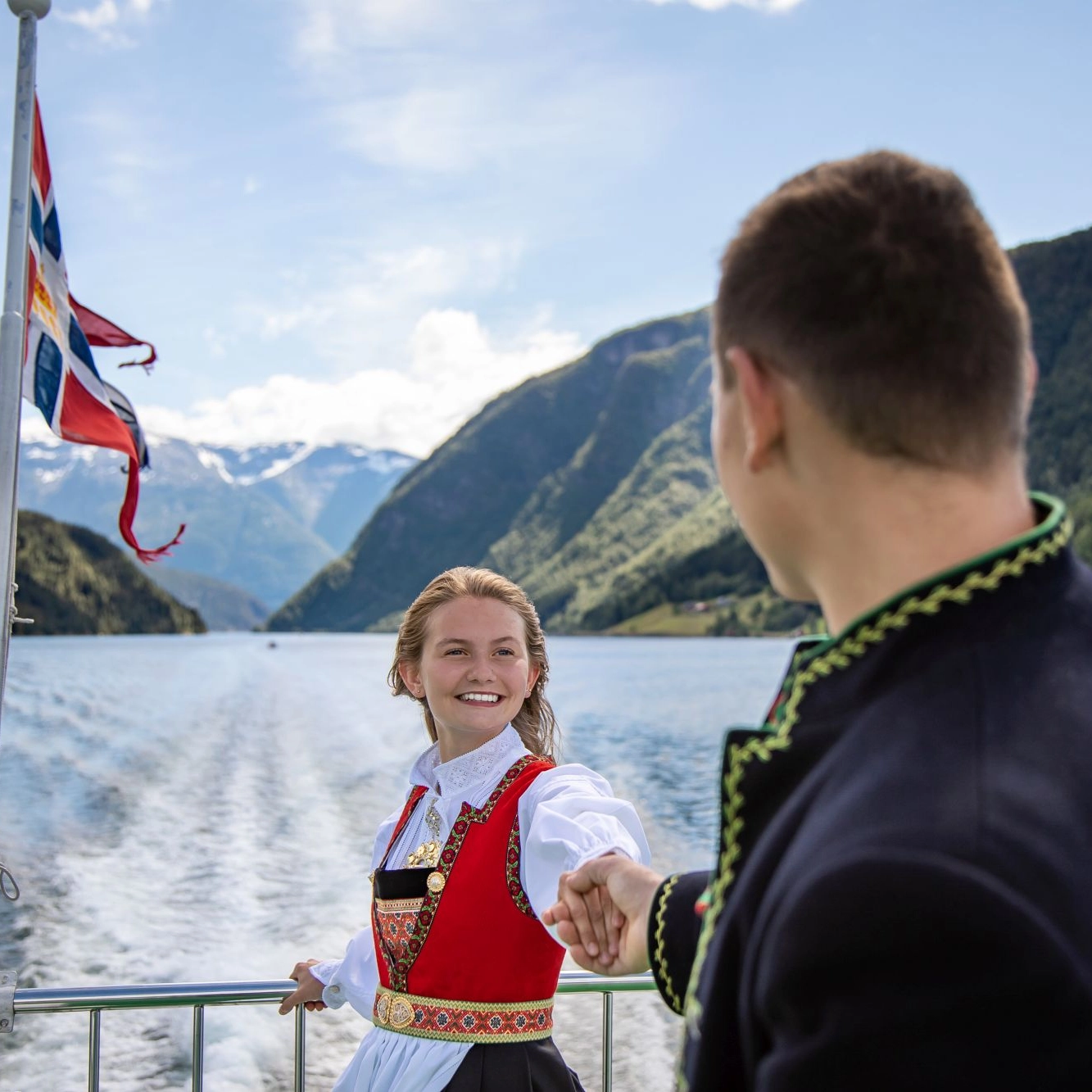 Wearing Norwegian national dress "bunad" on the Sognefjord in a nutshell tour - Norway