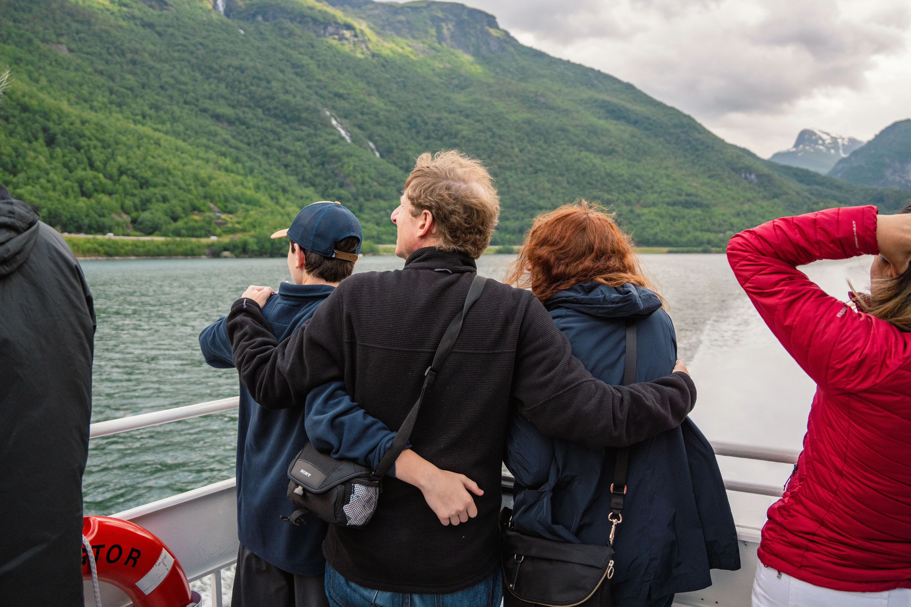 Family hugging and looking out on the Sognefjord