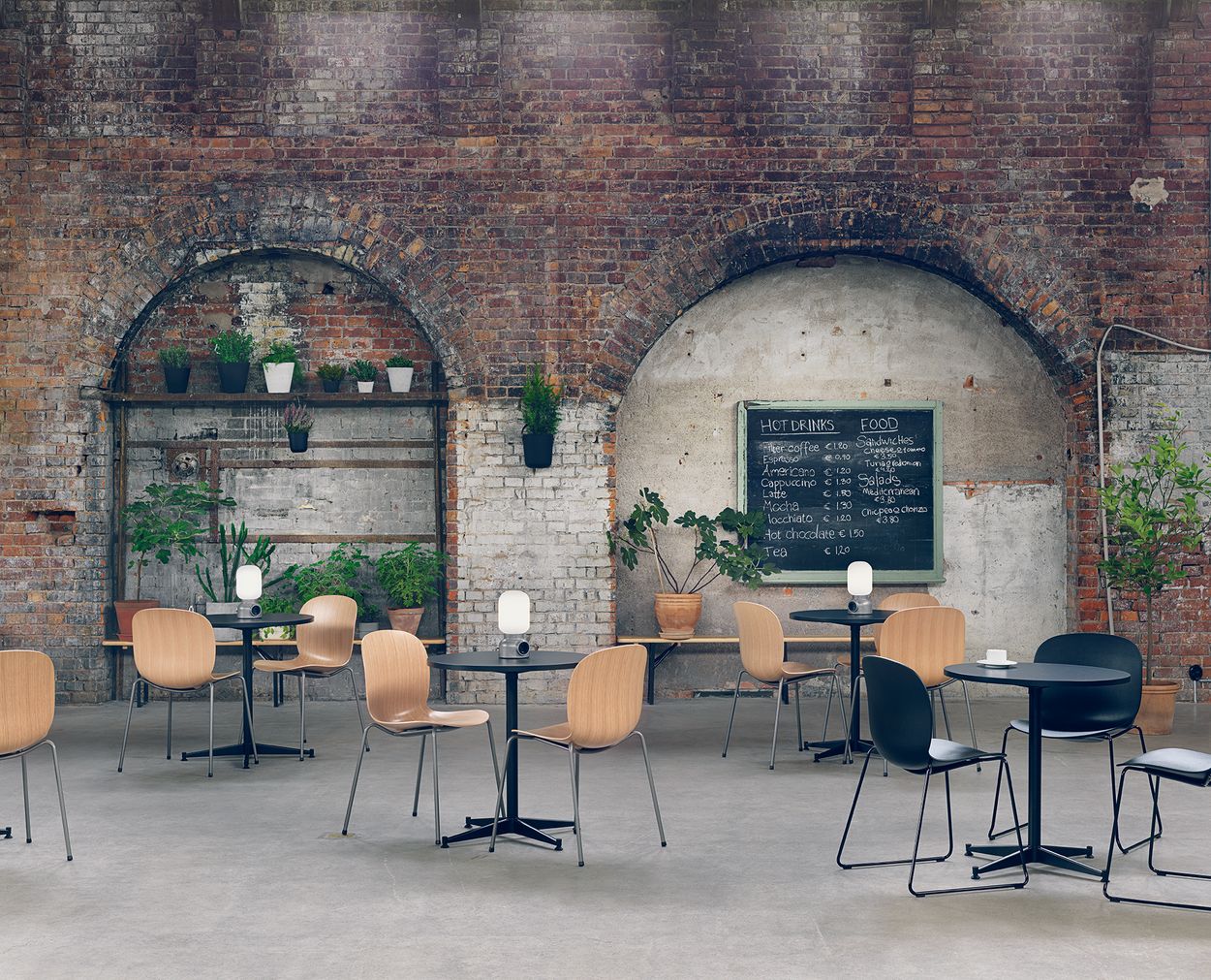 several noor chairs in a canteen. With a wooden seat and steel base