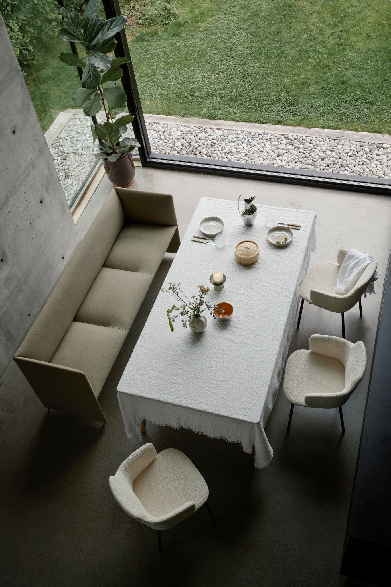 Ada Chair designed by Jonas Stokke for LK Hjelle, three white Ada chairs with a table with white cloth and a white sofa.