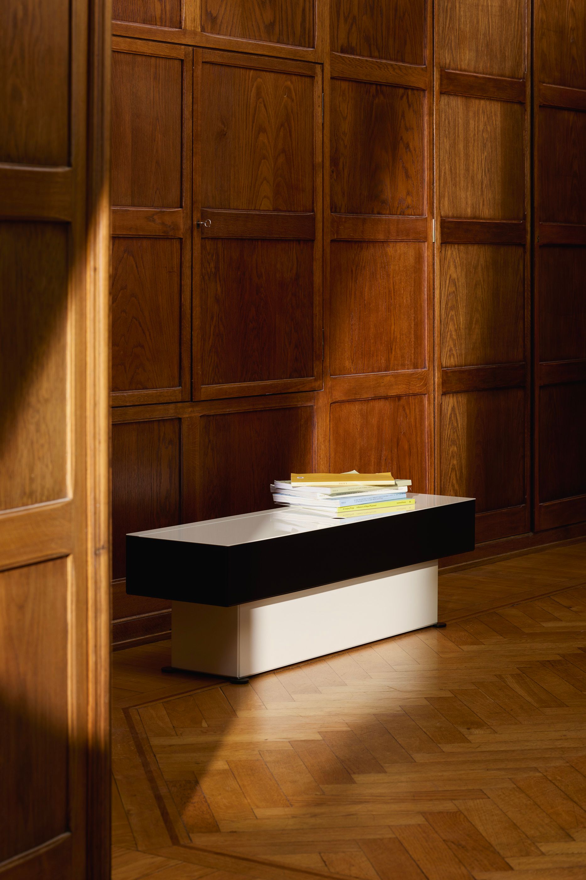 Black and white stroage unit in wooden meeting room