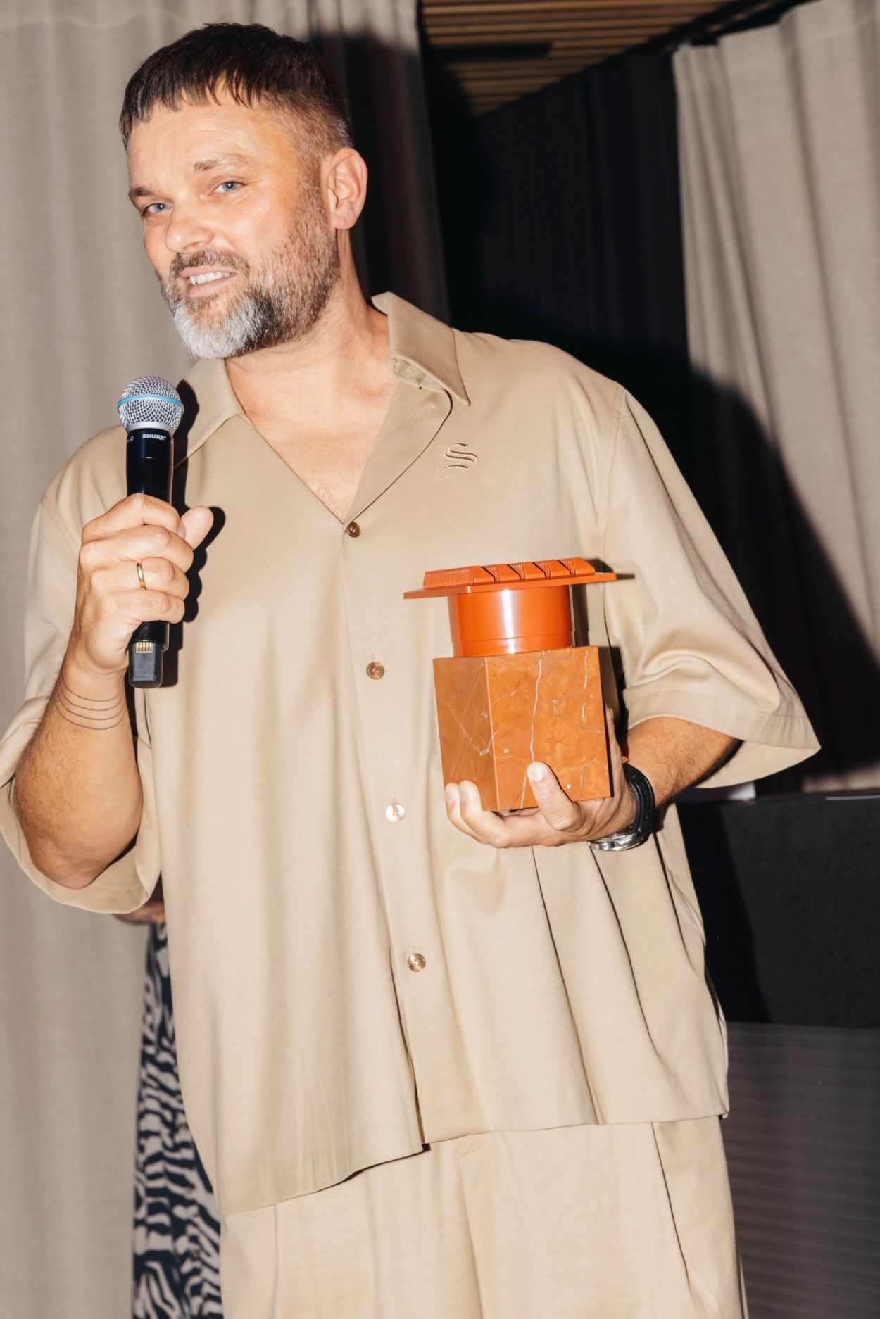 architect holding red award prize