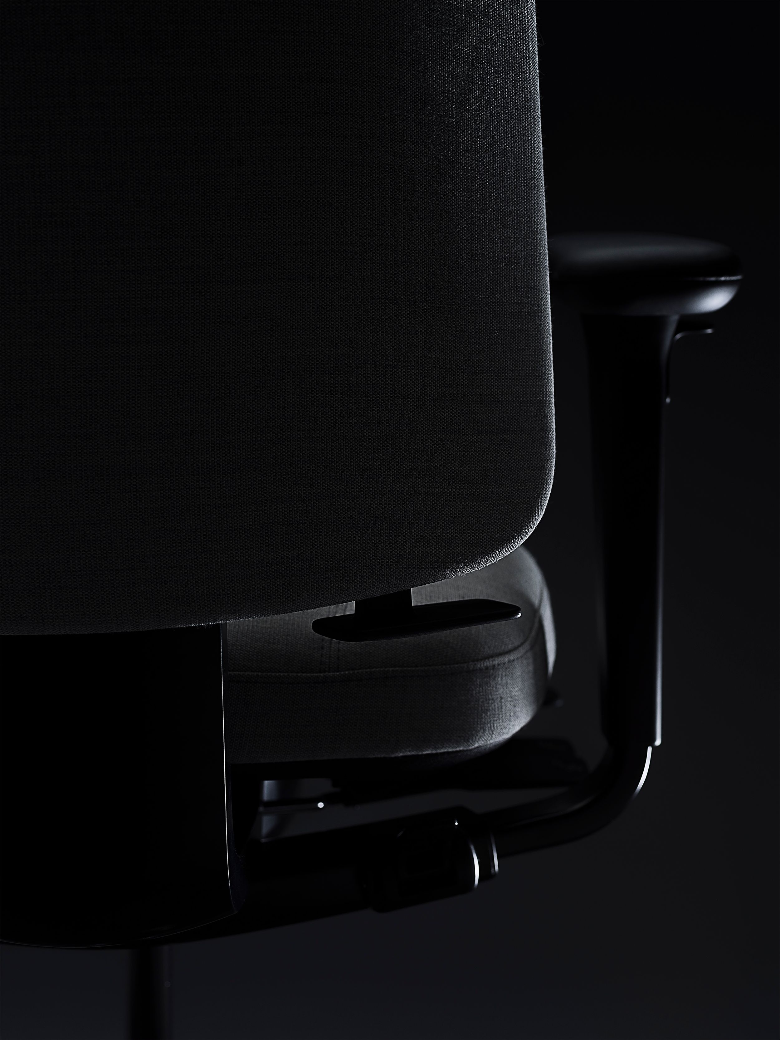 RH Logic redesigned by Jonas Stokke, grey office chair in black surroundings, back side, detail