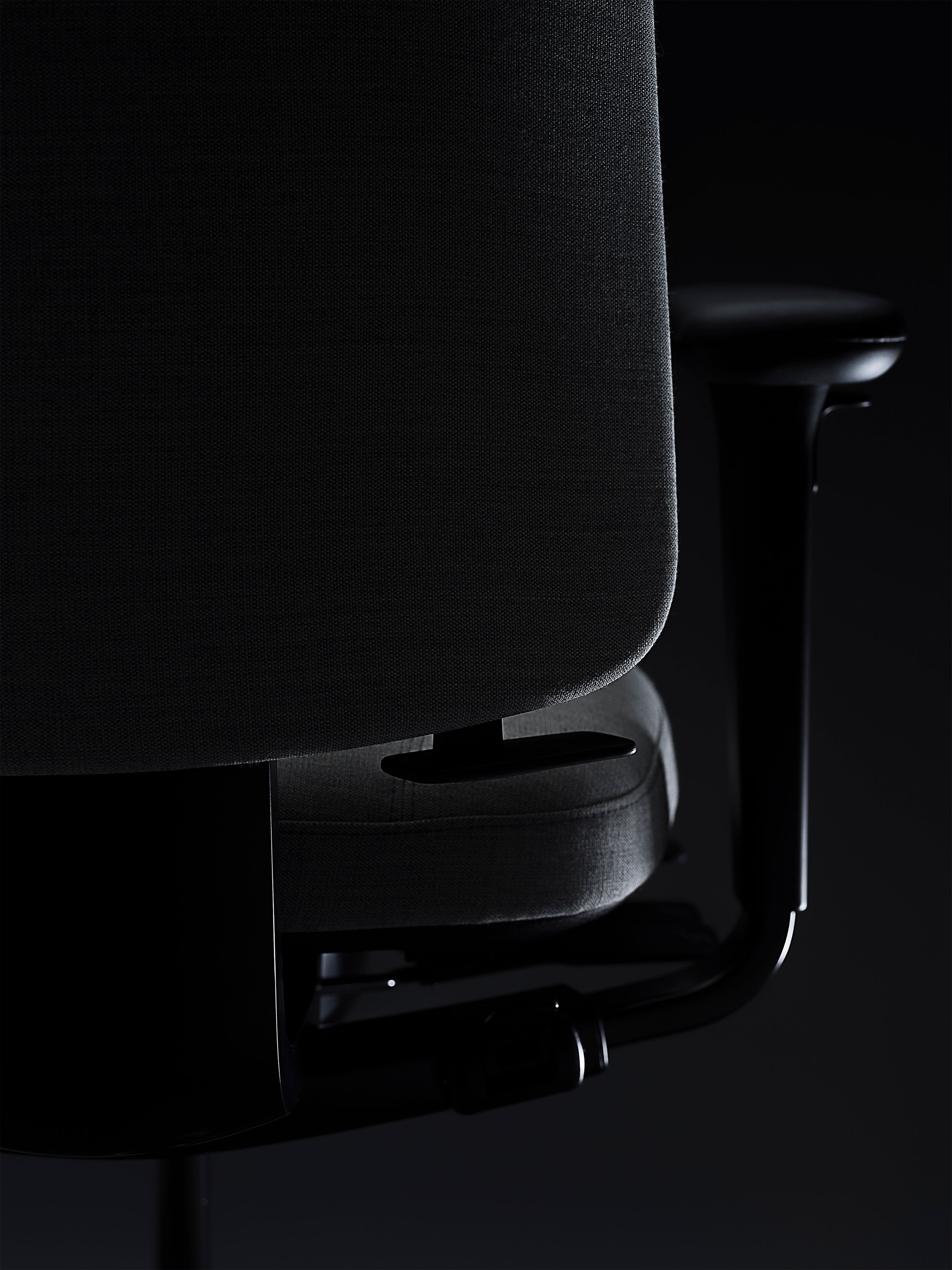 RH Logic redesigned by Jonas Stokke, grey office chair in black surroundings, back side, detail