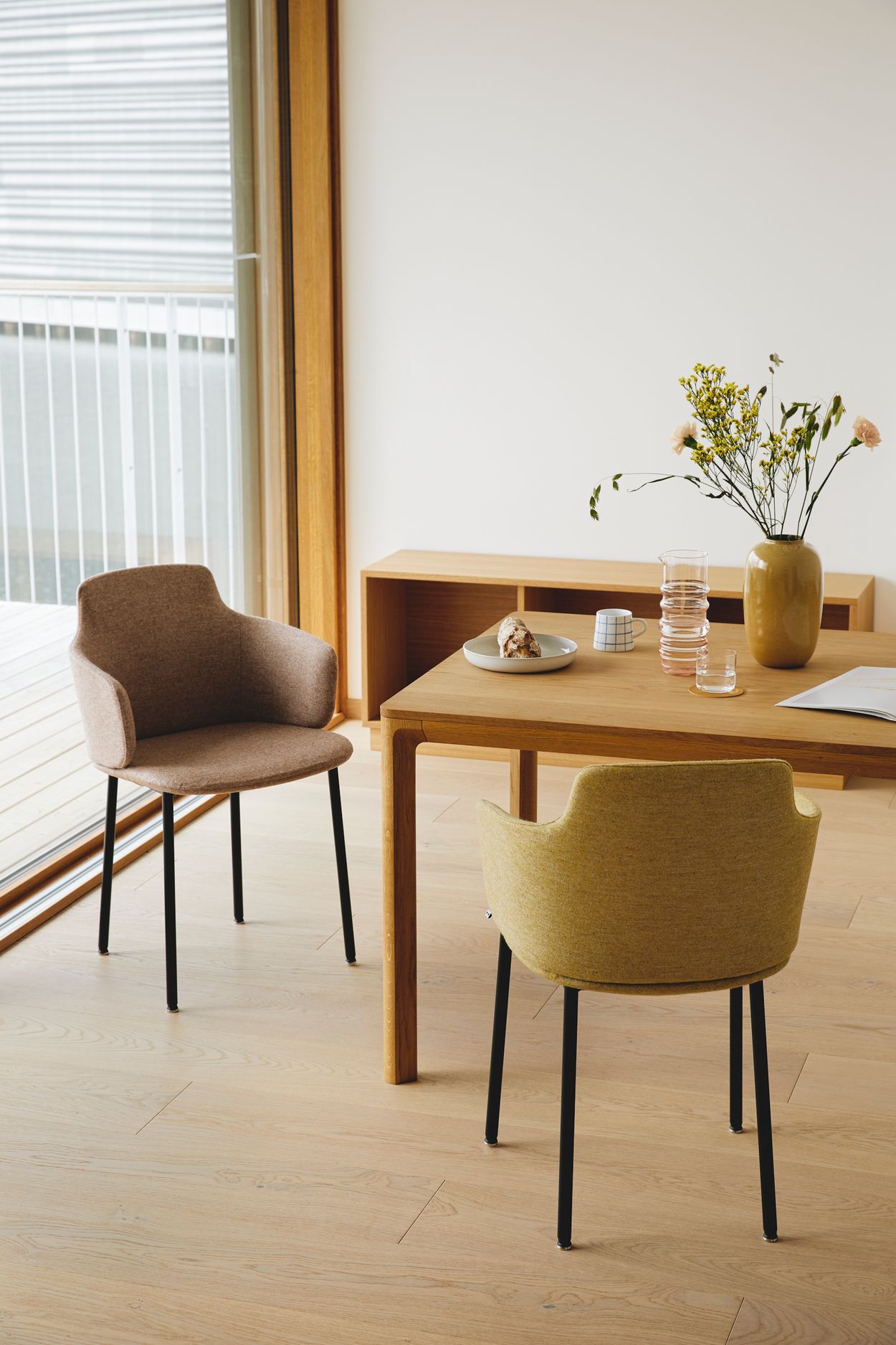 Ada chair designed by Jonas Stokke, next to dining table