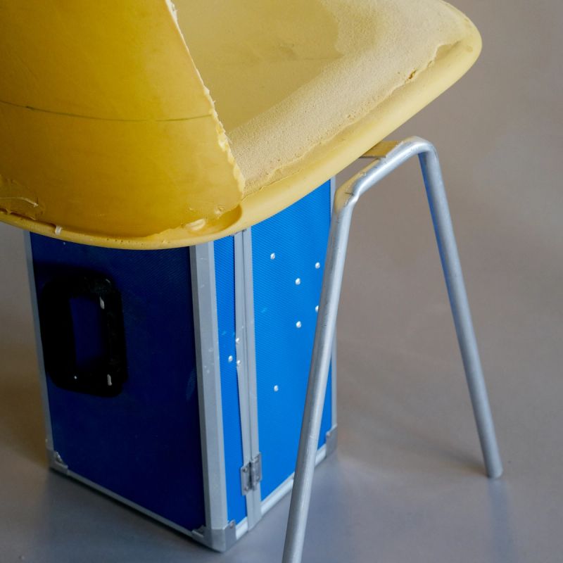 upholstered chair designed for LK Hjelle. One chair next to a table designed by Jonas Stokke, The chair is upholstered and on four black steel legs.