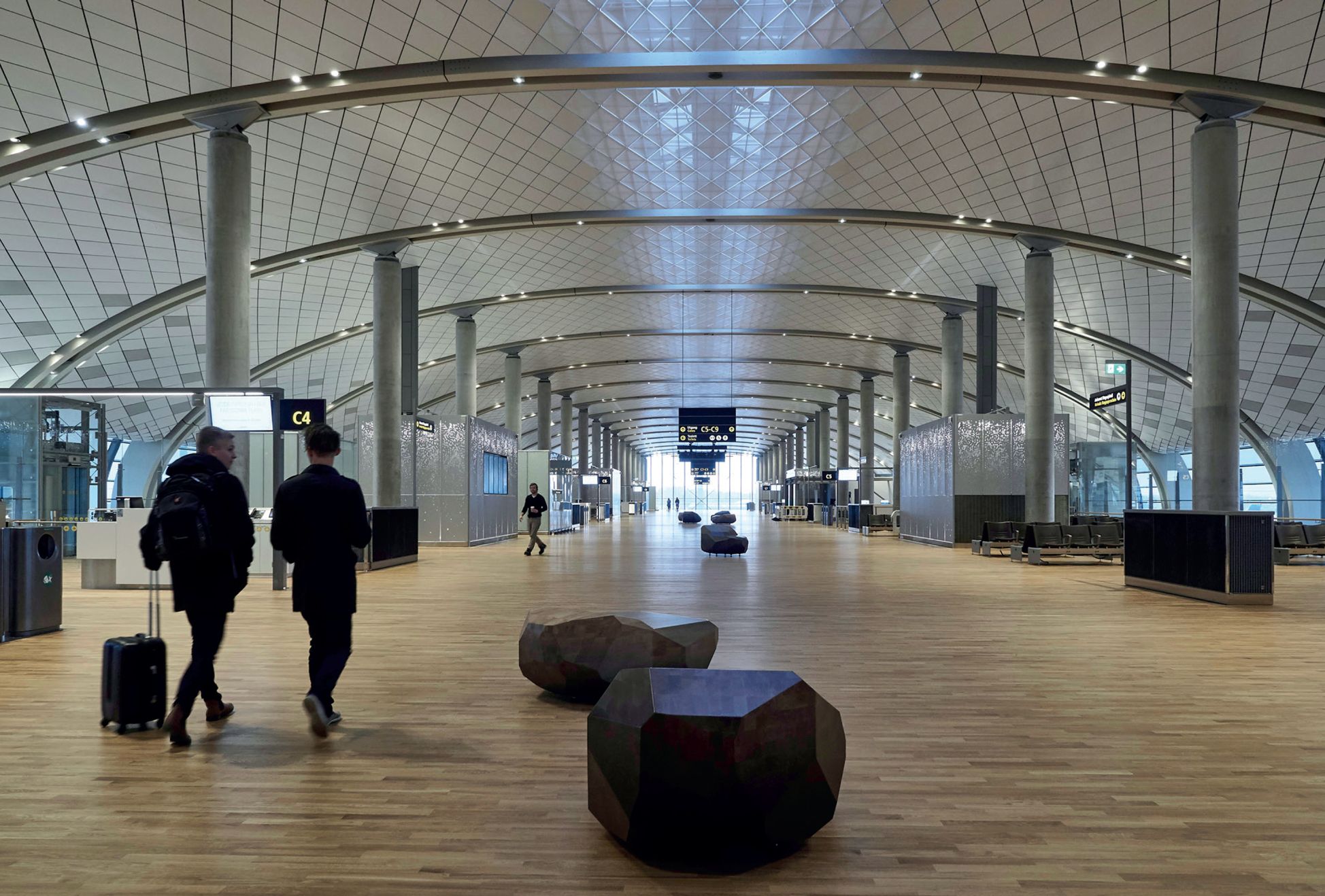 Wooden block for seating in airport terminal building in Oslo. Designed by Jonas Stokke
