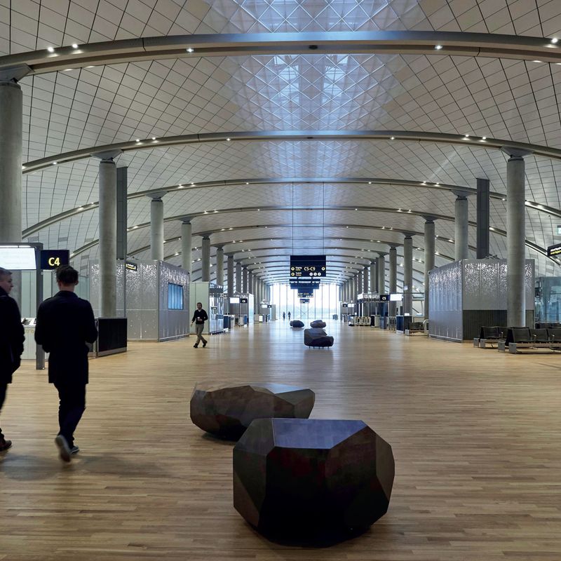 Wooden block for seating in airport terminal building in Oslo. Designed by Jonas Stokke