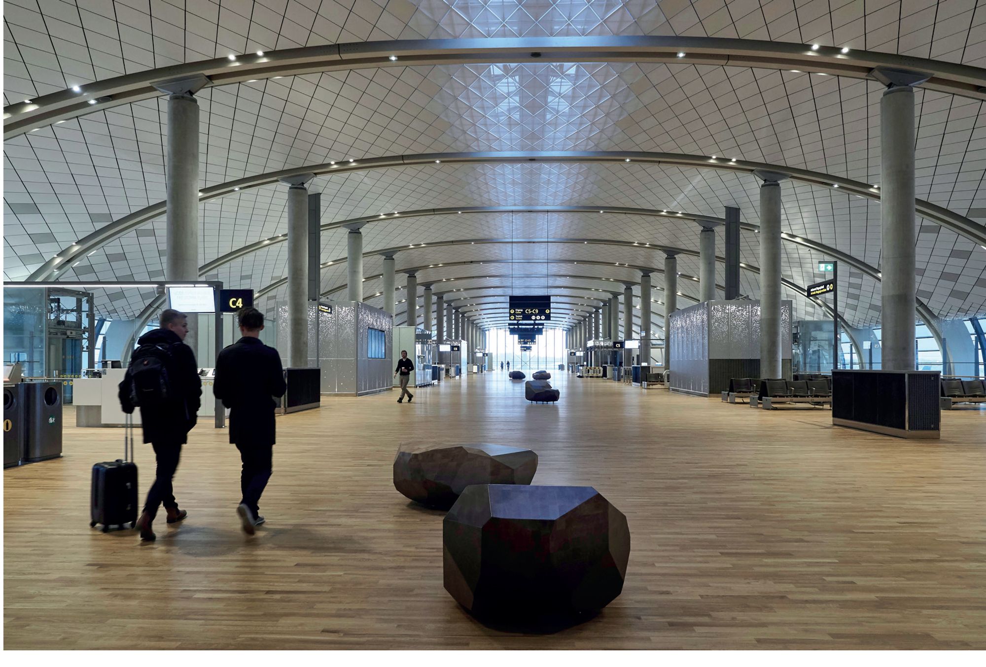 Gateway to Scandinavia designed by Jonas Stokke, wooden benches inspired by stones, alternative seating for an airport