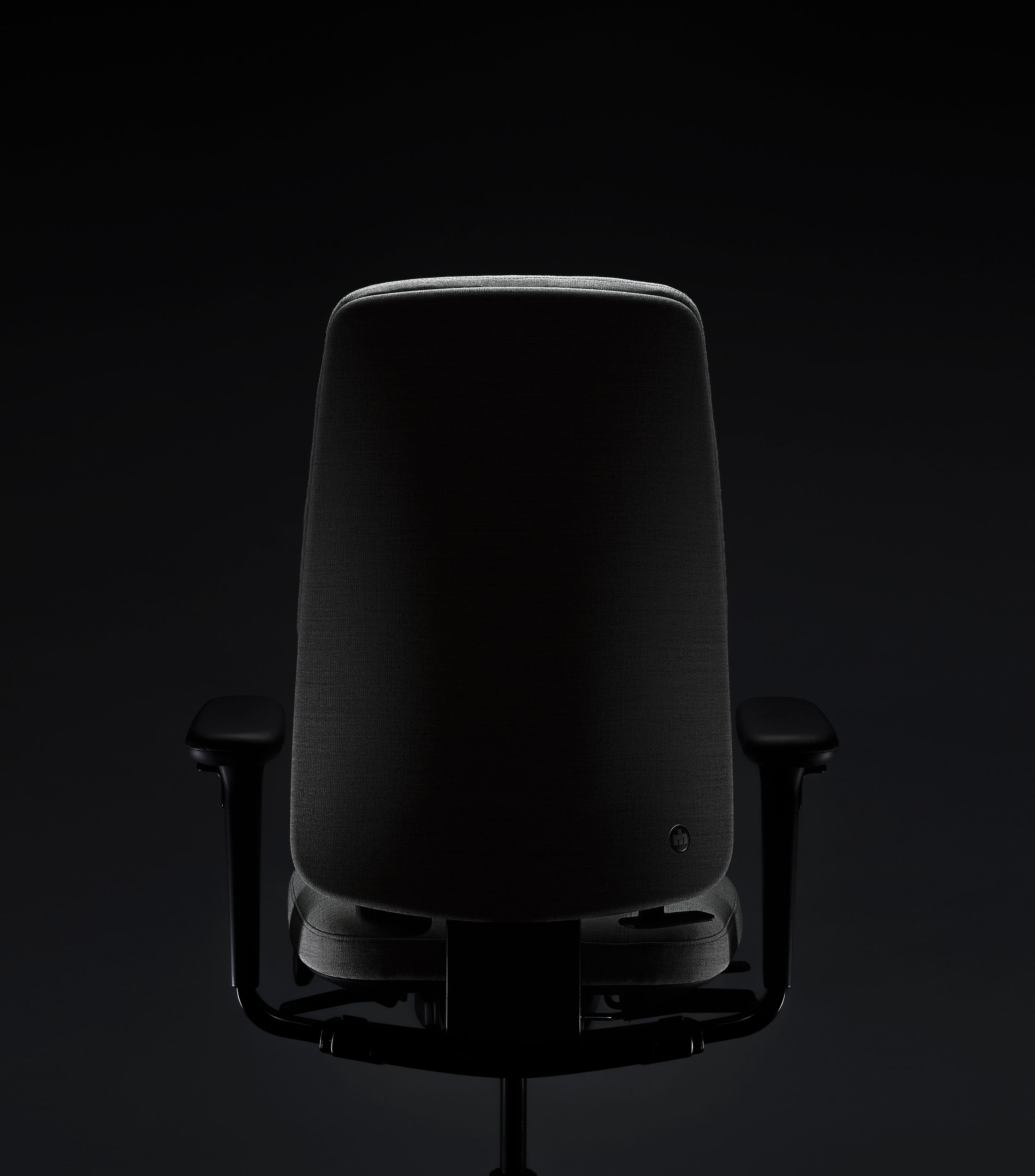 RH Logic redesigned by Jonas Stokke, grey office chair in black surroundings, back side