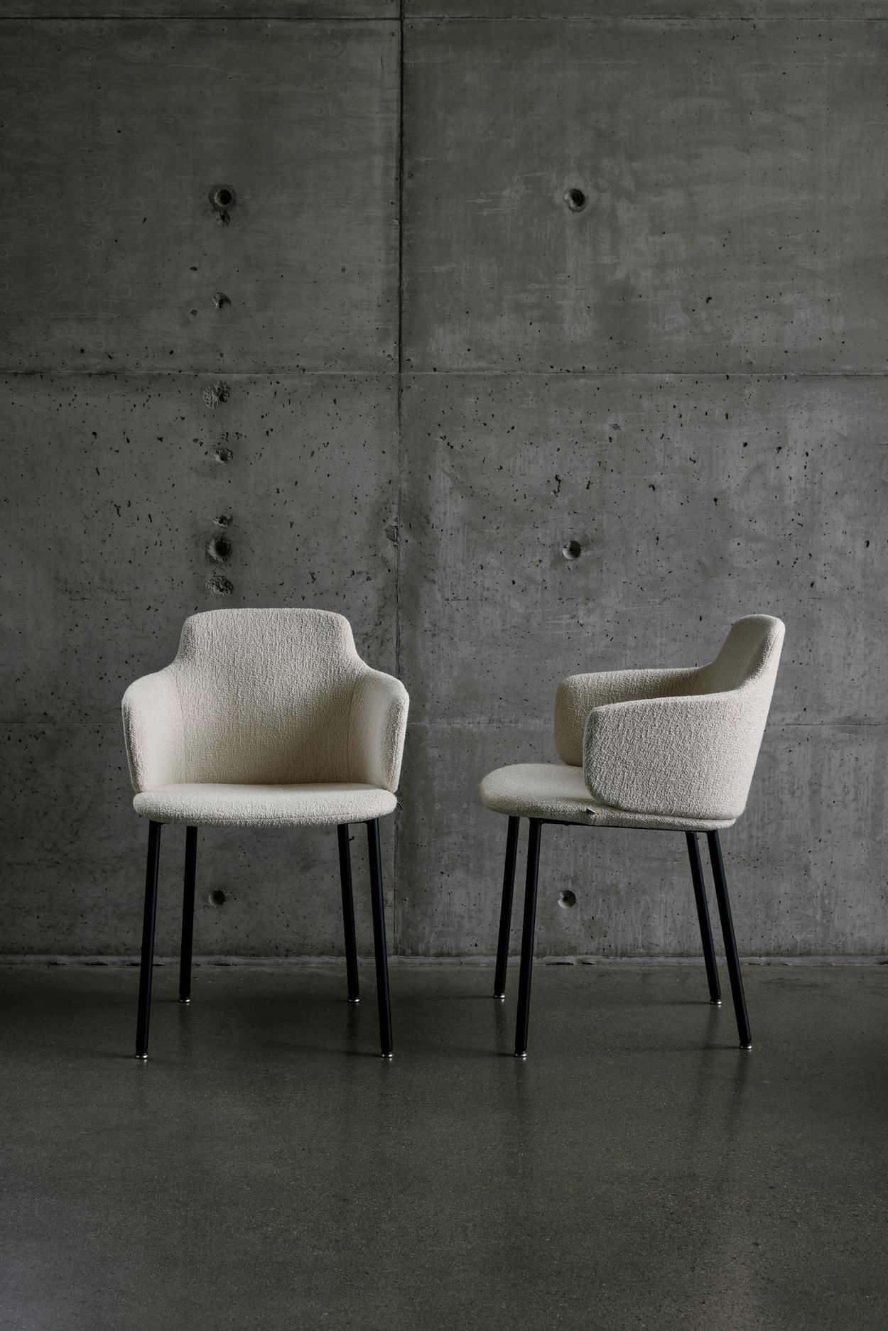 ada chair in light fabric and black legs seen from the side