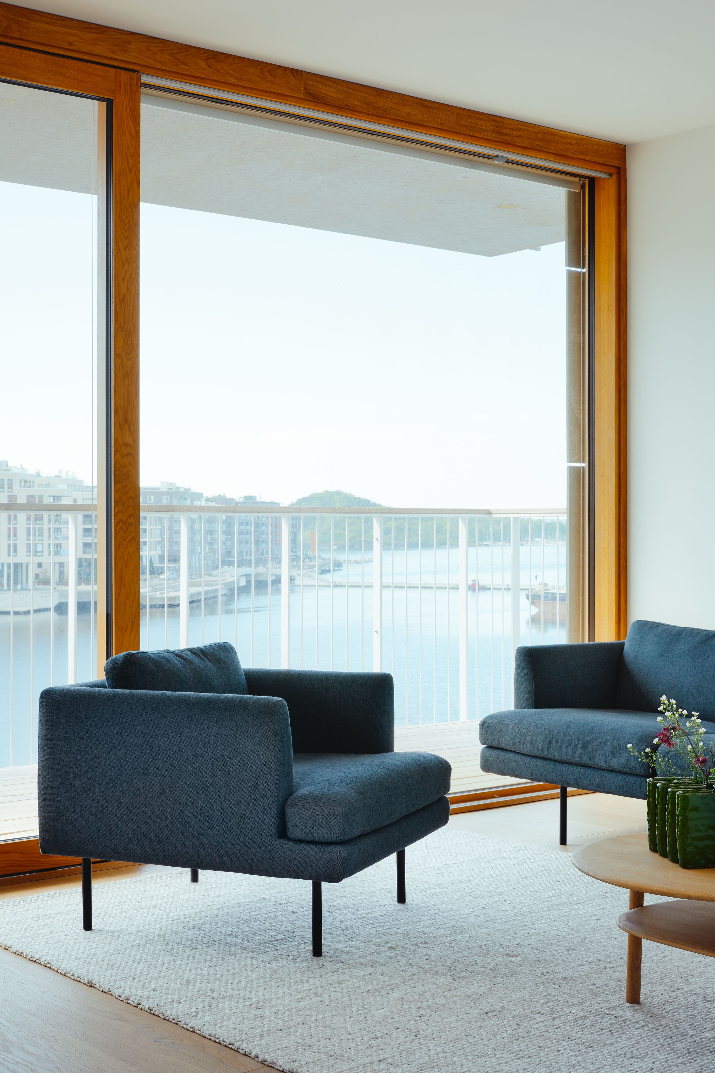 sofa chair in fron of large winown in harbour view apartment in Oslo