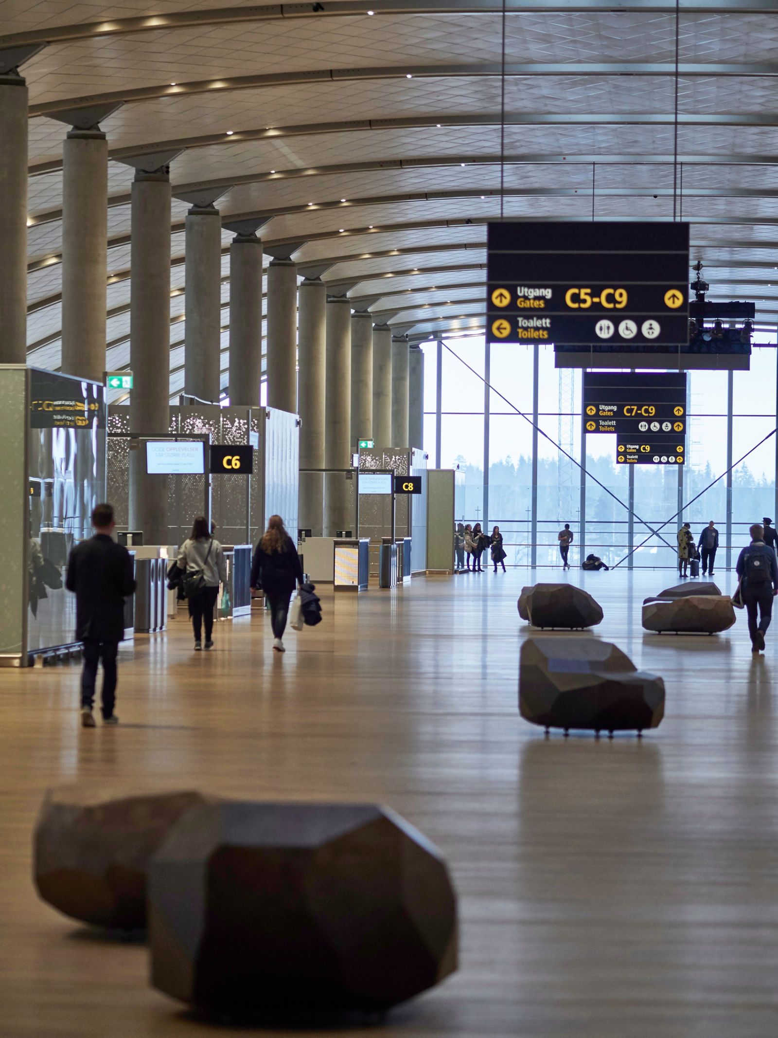 Gateway to Scandinavia designed by Jonas Stokke, wooden benches inspired by stones, alternative seating for an airport