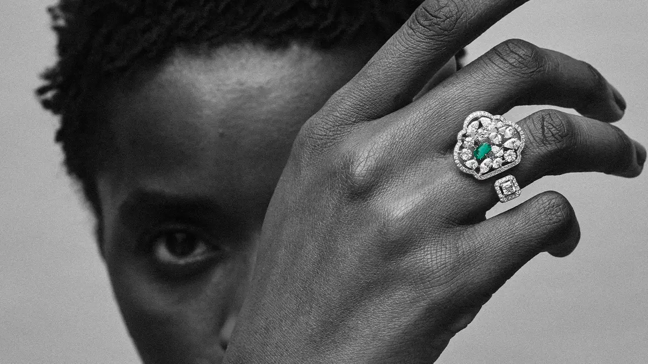 Banner image of a woman wearing Zambian emerald ring