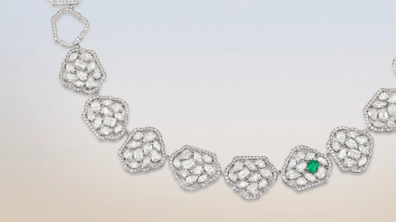 Banner image of a woman wearing Zambian emerald ring
