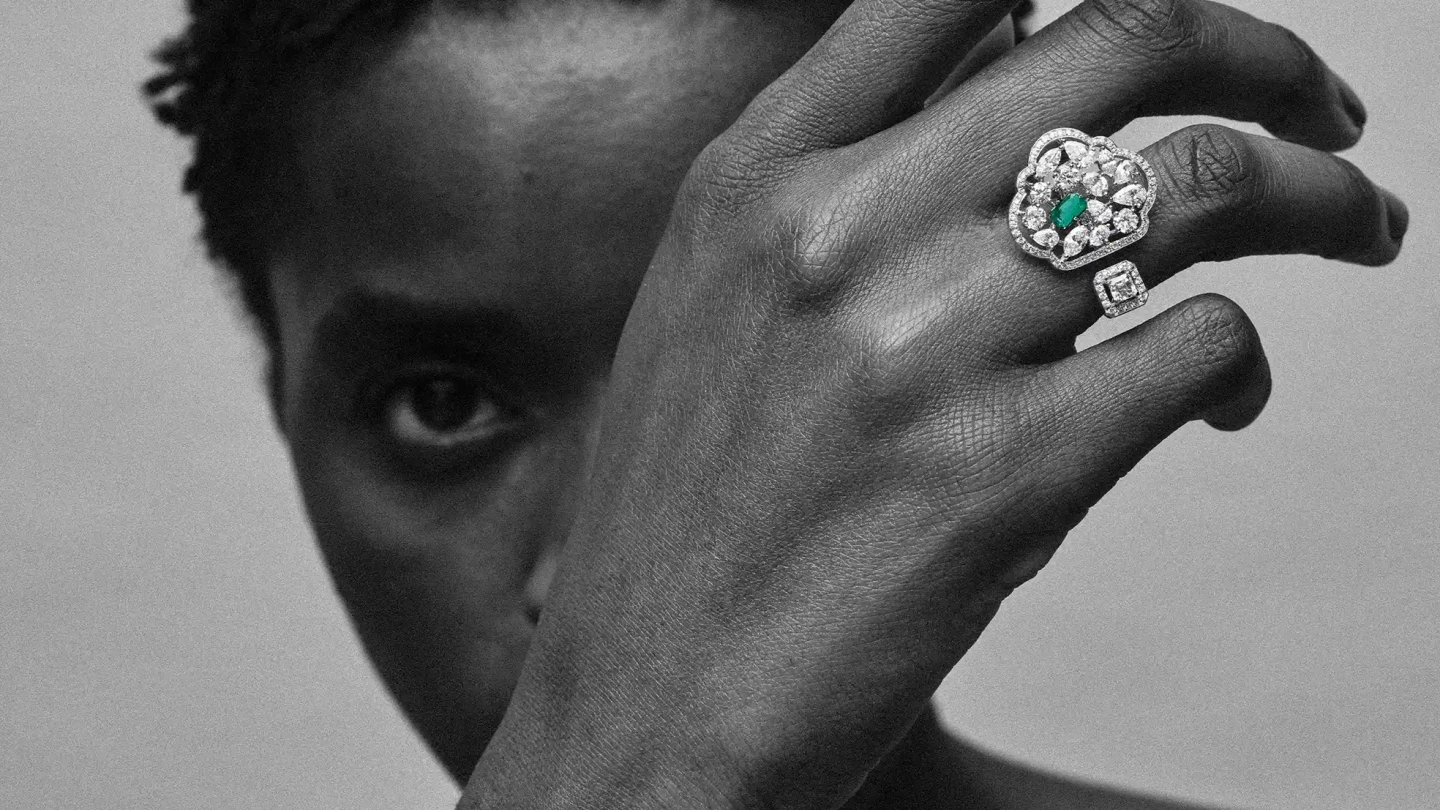 Woman wearing diversa zambian emerald 18k white-gold ring