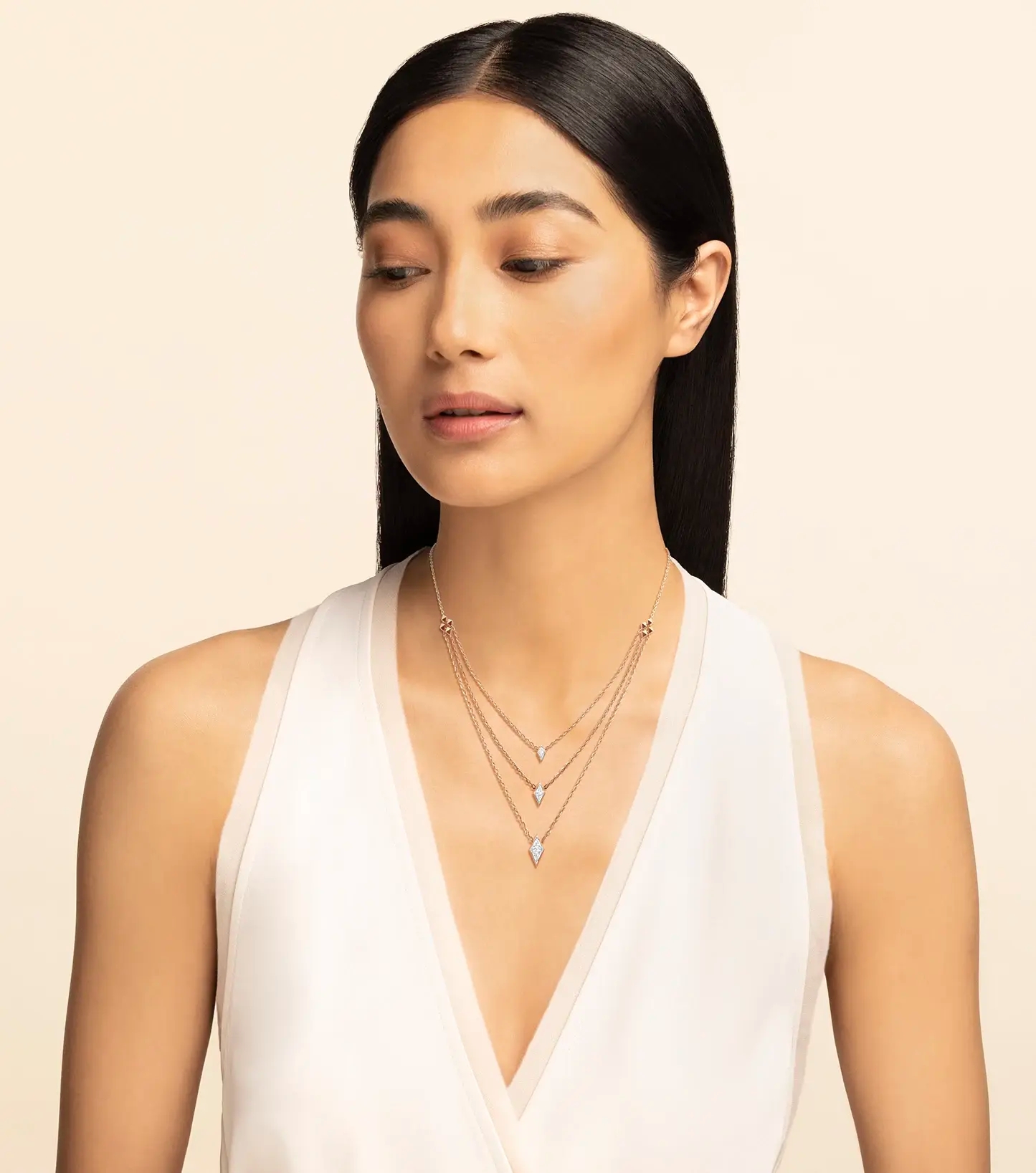 Woman wearing 18k rose gold and diamond necklace