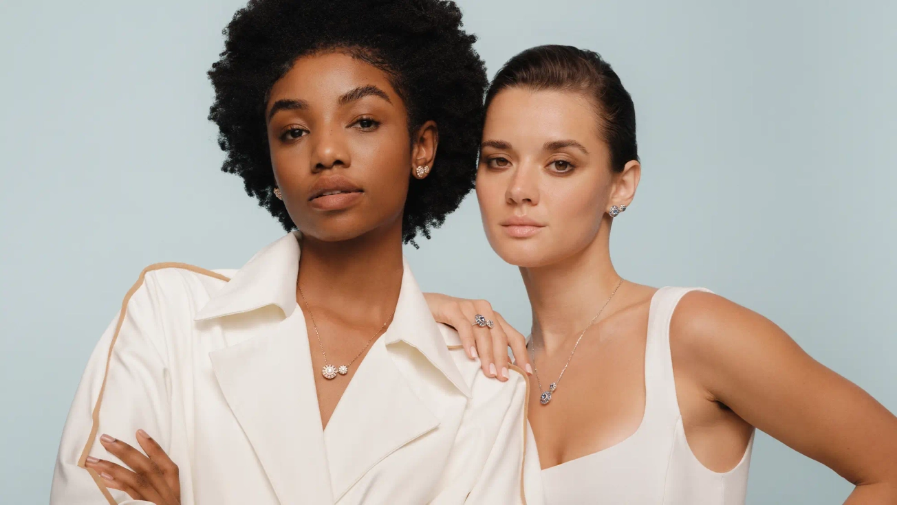 Two woman wearing diamond and 18k rose gold jewellery