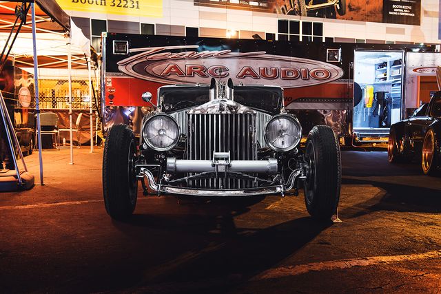 A vintage Rolls-Royce on the ARC Audio stand at night