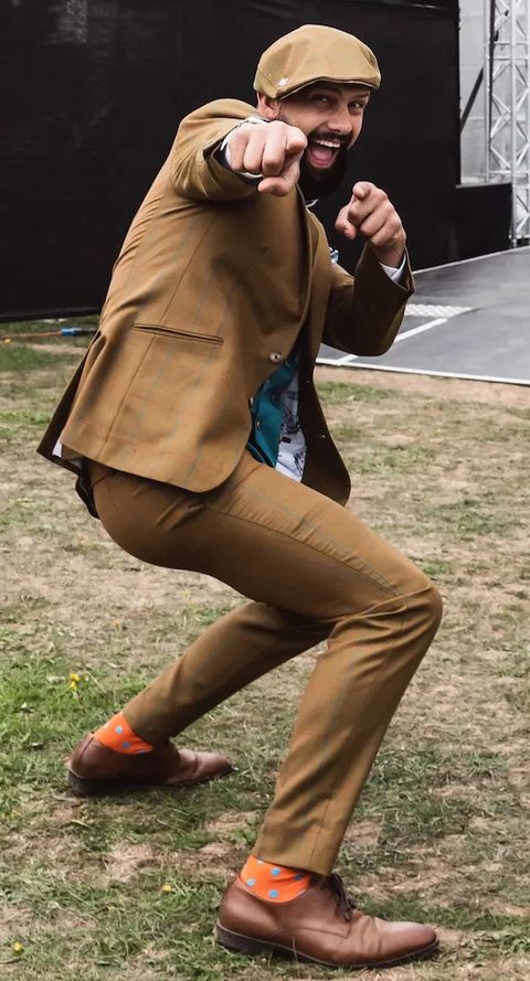 Sam in his Mr Bean tweed suit throwing a mock punch at the camera