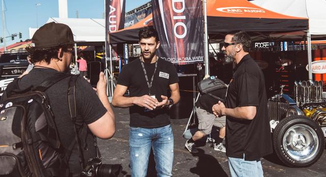 Sam with friends at a car audio stand