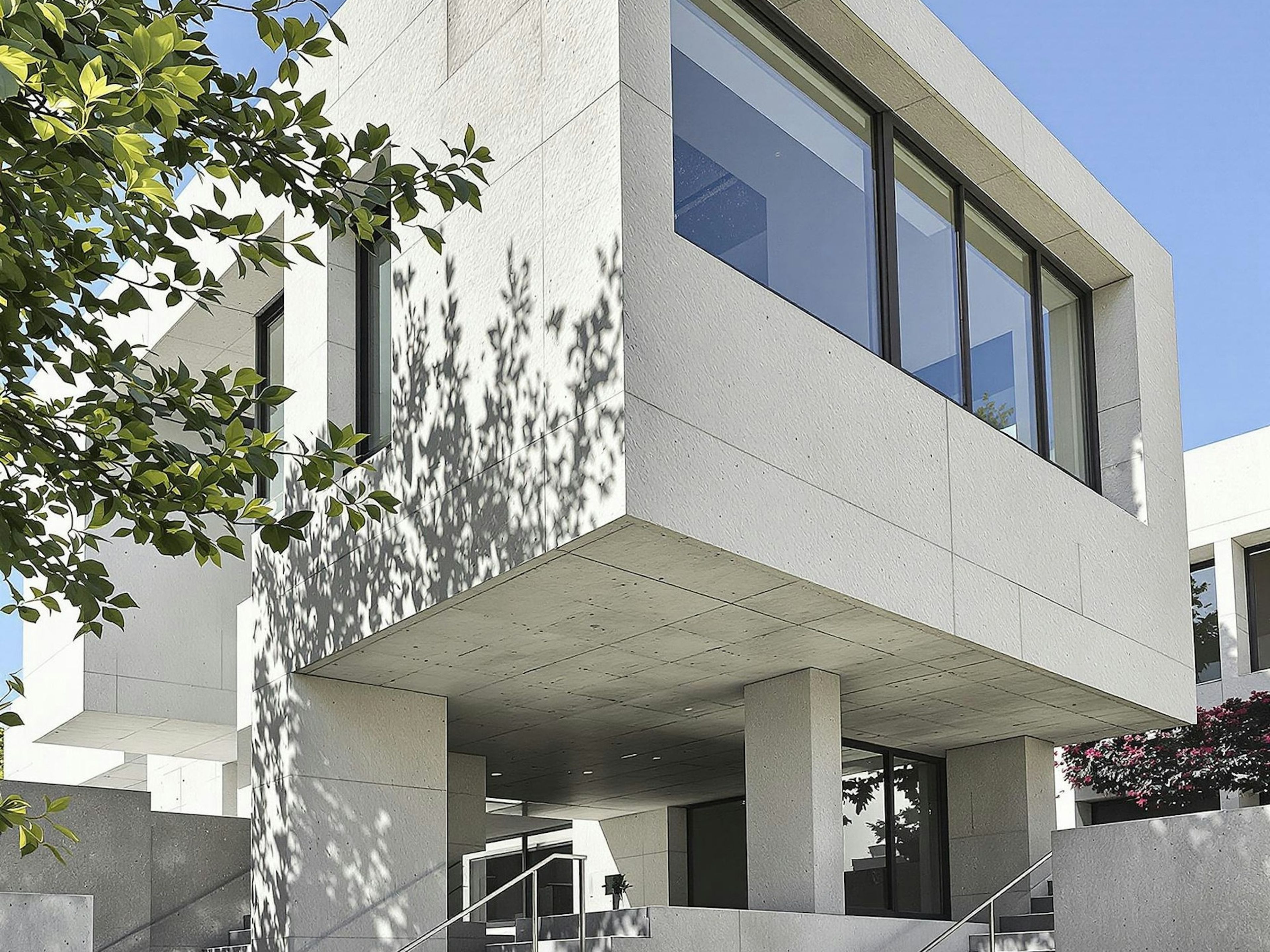 A white concrete building against a clear sky
