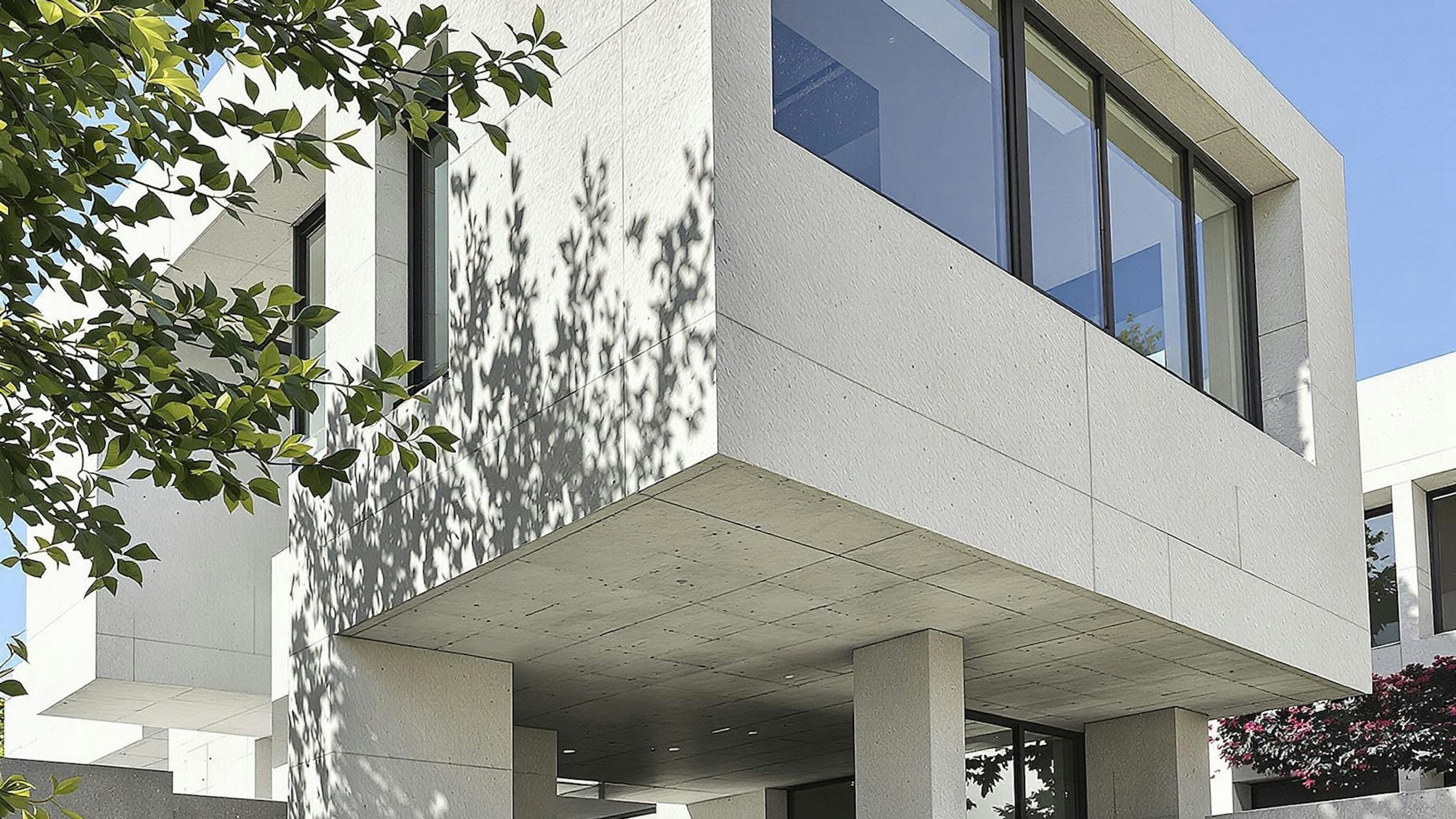 A white concrete building against a clear sky