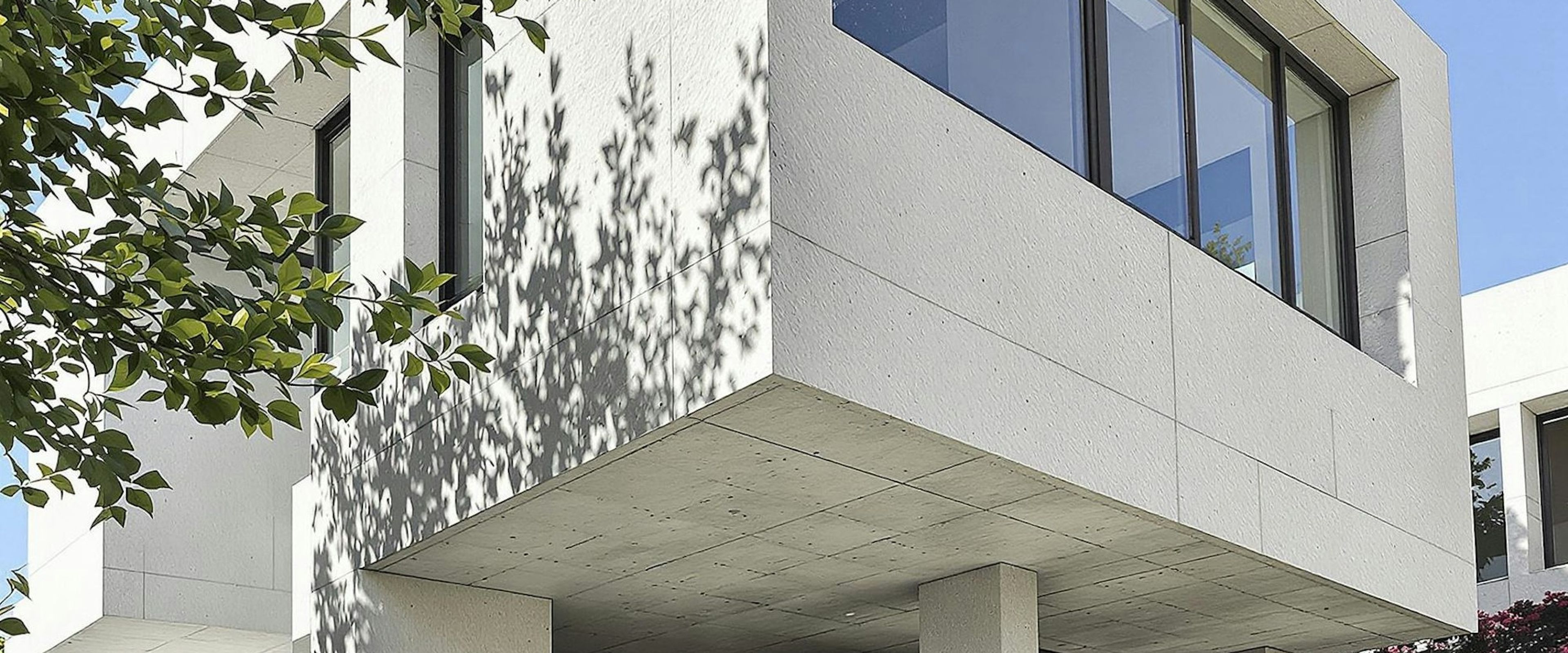 A white concrete building against a clear sky